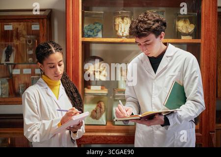 Young Adult Woman and Caucasian Man Studying Anatomy in Laboratory Stock Photo