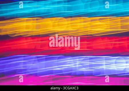 Colorful light streaks creating dynamic abstract pattern with horizontal lines in blue, gold, red, purple, pink hues Stock Photo