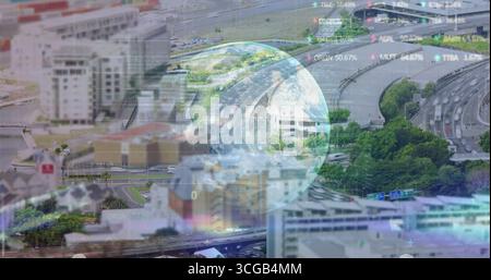 Floating translucent globe overlaying highway interchange, displaying stock tickers over cityscape Stock Photo