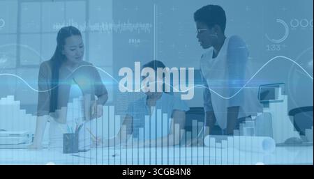 Collaborating business team reviewing documents in meeting room, with laptop and analytics overlay Stock Photo