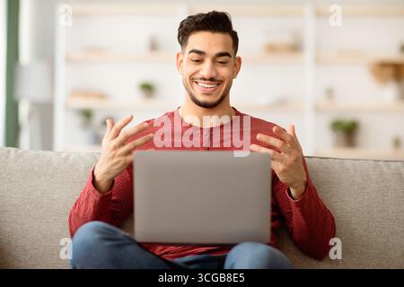 Positive arab guy having video chat with girlfriend Stock Photo