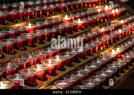 buring votive candles inside Trinity Church Stock Photo