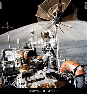 Astronaut Eugene A. Cernan, Apollo 17 commander, approaches the parked Lunar Roving Vehicle (LRV) on the lunar surface during the flight's third period of Extravehicular Activity (EVA-3). South Massif can be seen in the background. The photograph was taken with a hand-held Hasselblad camera by scientist-astronaut Harrison H. Schmitt, lunar module pilot. While the two explored the surface of the moon, astronaut Ronald E. Evans remained with the Command and Service Modules (CSM) in lunar-orbit. NASA Photo Stock Photo