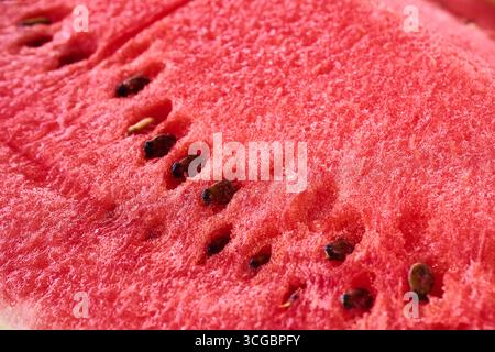 Fresh, ripe watermelon slice with visible seeds and textured flesh, perfect for summer refreshment Stock Photo