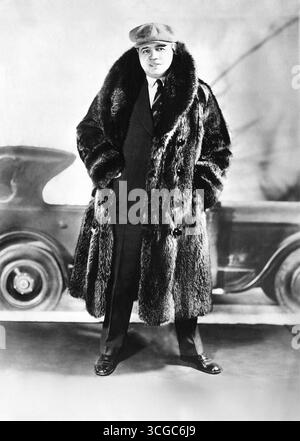 Super star and baseball legend, Babe Ruth wearing a fur coat in front ...