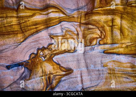 Abstract Sandstone Texture with Swirling Layers and Earth Tones Stock Photo