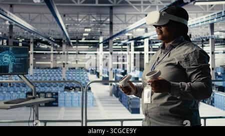 Data center system administrators deploy machine learning software on infrastructure racks. Team of server hub IT experts train AI systems with datasets using tablet to support applications, camera A Stock Photo