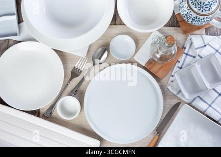 A top down view of a restaurant dinner place setting filled with empty dishes on a table, in a still life setting. Stock Photo