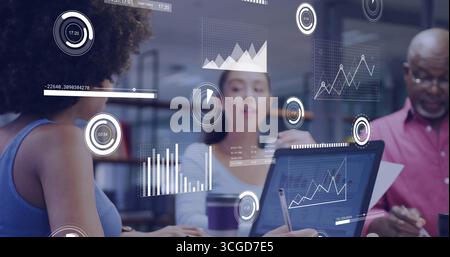 Collaborating three professionals analyzing chart overlays in meeting room, with laptops coffee cup Stock Photo