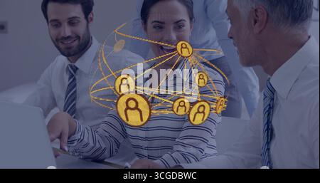 Collaborating business team discussing data on laptop in conference room, digital network overlay Stock Photo