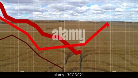 Displaying bright red arrow line trending upward across harvested field grid, with dark red line Stock Photo