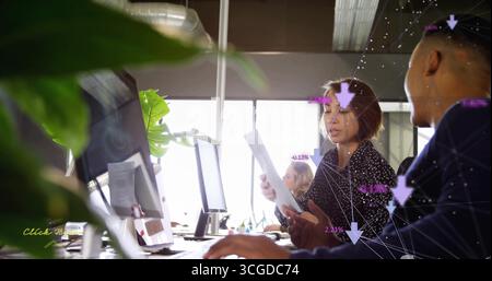 Discussing document and analyzing digital overlays by business team in office with plant Stock Photo