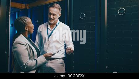 Tablet, team and people in data center for talking, cloud computing or shock for IT solution. Collaboration, tech and engineer in server room for Stock Photo