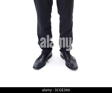 Man in dark suit standing, close up on shoes, isolated on white background Stock Photo