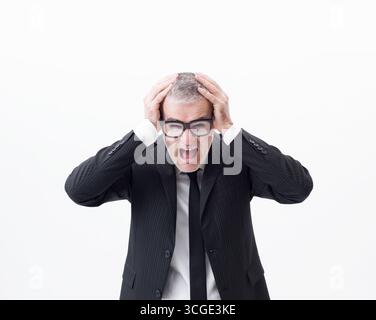 Portrait of a middle-aged businessman screaming and despairing, half-length isolated on white background Stock Photo