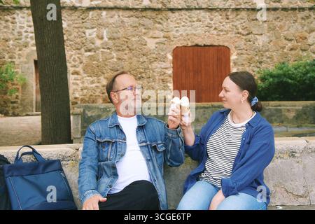 Outdoor portrait of happy middle age couple eatimg ice cream Stock Photo