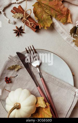 Minimal thanksgiving table setting with fork and pumpkin.. Stock Photo