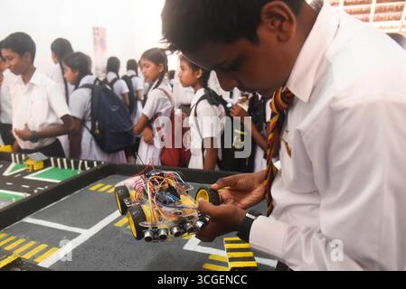 Knight-Ro 2025 Education and Innovation exhibition, Sri Lanka A student checks his robot car at the Knight-Ro 2025, a ground breaking education and innovation exhibition in Colombo, Sri Lanka on August 28, 2025. Knight-Ro 2025, held from August 28 to 30 is a landmark education and innovation exhibition organized by Thurstan College to mark its 75th anniversary. Billed as the citys largest event of its kind, it brings together over 200 exhibits from students, government, and private partners, showcasing cutting edge fields such as robotics, AI, engineering, virtual reality, and sustainability a Stock Photo
