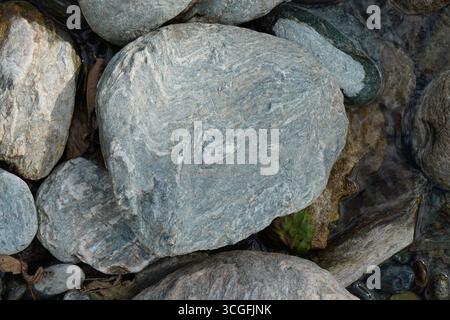 Closeup of riverbed textured gray stones background Stock Photo
