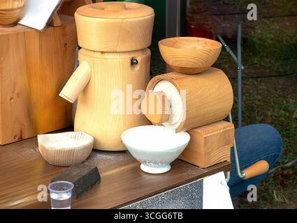 Flour mill grinder machine on wooden table in countryside Stock Photo