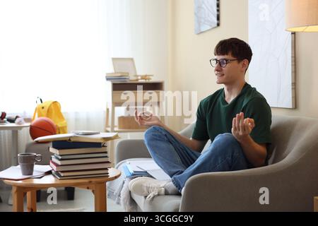 Student preparing for exam and meditating at home Stock Photo