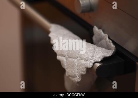close-up image of a gray rag or towel for cleaning in a kitchen. home cleaning supplies rag. gray microfiber towel kitchen Stock Photo
