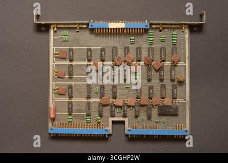 Close-up of a vintage computer expansion card with electroni components, integrated circuits and connector pins, photographed in Prague, Czech Republi Stock Photo
