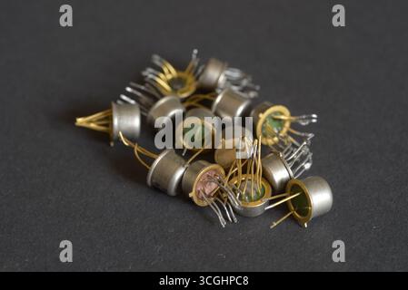 Antique electronic components with metallic housings on table. Stock Photo