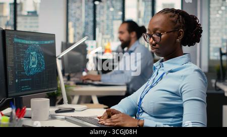 Equity analyst uses AI for companies earnings research to assess stock market value, taking notes. Trader conducts financial analysis to improve investments using artificial intelligence Stock Photo