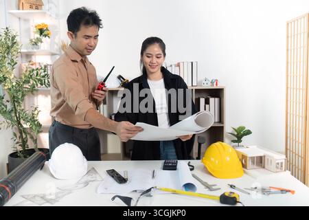 Architects Discussing Building Models and Blueprints Stock Photo