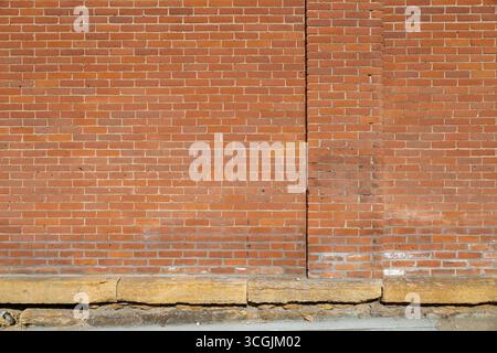 Full frame abstract texture background of a weathered old orange clay brick wall texture background Stock Photo