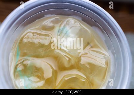 Macro top view of a plastic coffee shop glass of iced tea, with ice Stock Photo