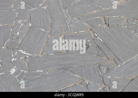 Full frame abstract texture background of a rustic patio surface comprised of large broken ceramic tiles in a mosaic style Stock Photo