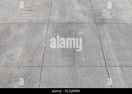 Full frame abstract texture background of a Rustic gray cement walking path with large rectangular lines Stock Photo