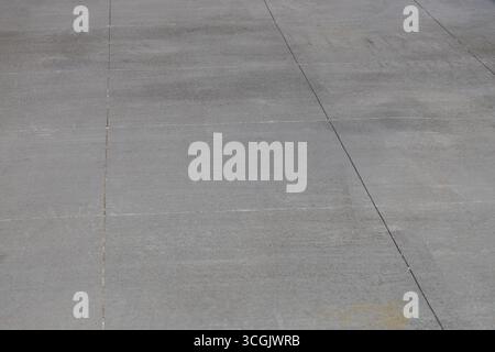 Full frame abstract texture background of a Rustic gray cement walking path with large rectangular lines Stock Photo