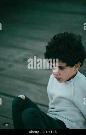 Scared liitle boy looking away Stock Photo