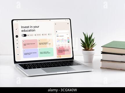 Modern laptop displaying an online education platform with diverse courses in business, technology, and creative fields. Investing in education concep Stock Photo