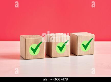 Check marks on wooden cubes represent approval, agreement, or completion of tasks, conveying a sense of accomplishment and validation Stock Photo