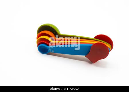 Multicolored measuring spoons for powders and liquids isolated on white background Stock Photo