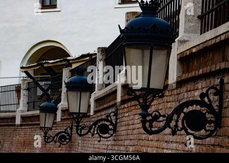 Street lamps mounted on a brick wall Stock Photo