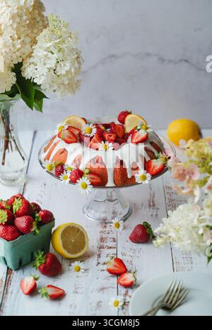 Summery strawberry lemon cake on white background. Stock Photo