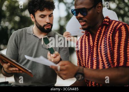 Multiracial business people meeting to analyze and discuss statistics, sales growth, and strategize innovative ideas for profitability. Stock Photo