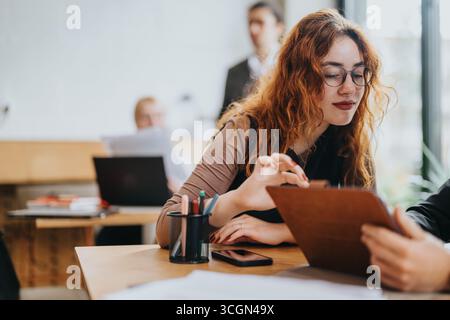 Young people collaborating on projects in a co working space with a casual and rustic atmosphere Stock Photo