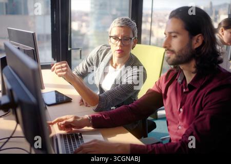 Business colleagues collaborating in modern office Stock Photo