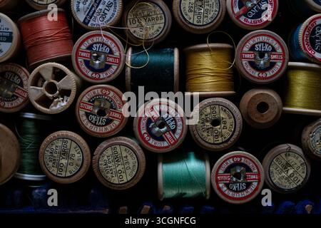 Variety of colourful sewing threads and cotton reels in a sewing box Stock Photo