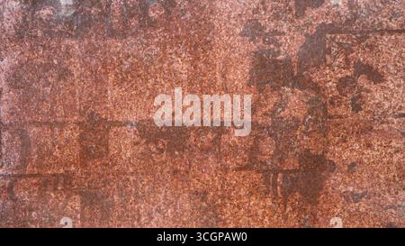 Rusting sheet metal, full frame textured backdrop of rusty flat iron with scratched and worn surface, graphic empty background of corroded old metal Stock Photo