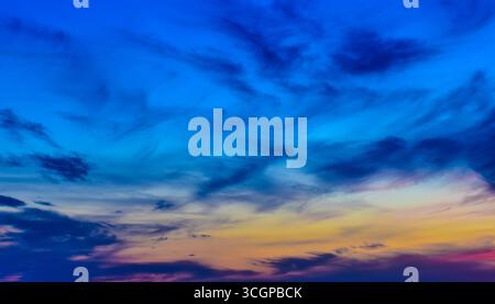 Mesmerizing sky view at dusk, glowing with magical hues, pastel clouds, and warm sunset radiance behind the veil. Stock Photo