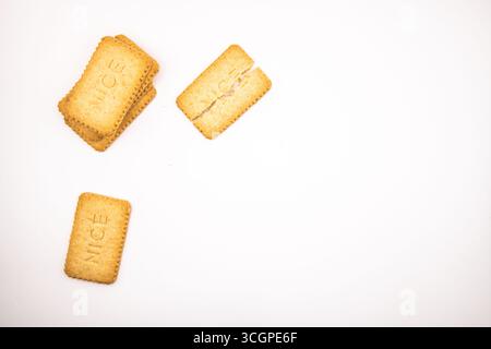 Selection of golden Nice biscuits arranged on a clean white background, ideal for food, snack, dessert, sweet treat, and baking concepts. Stock Photo