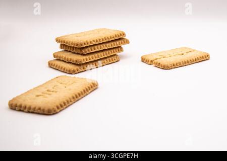 Selection of golden Nice biscuits arranged on a clean white background, ideal for food, snack, dessert, sweet treat, and baking concepts. Stock Photo
