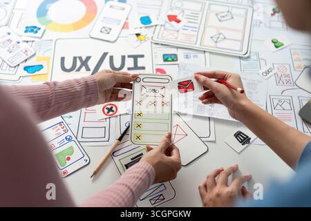 UX and UI Design Exploration. Team discussing mobile app layout and design elements. Stock Photo